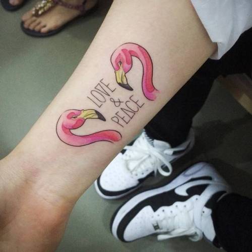 “Love and peace” flamingo tattoo on the right... small;tiny;bird;yellow;pink;little;forearm;doy;english;flamingo;lettering;love and peace;quotes;english tattoo quotes;black;languages;animal