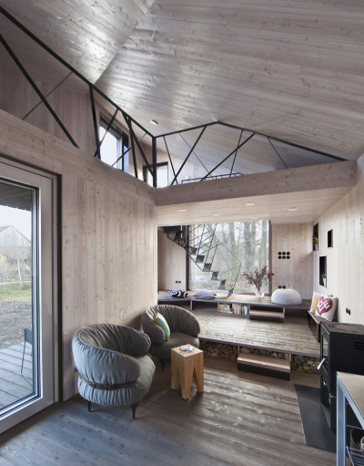 archatlas:<br /><br />Zilvar House ASGK Design<br /><br /><br /><br /><br />The experimental low-energy wooden house Zilvar won honorable mention the Architecture Grand Prix in 2014 in the Family House category. The land is located in the outskirts of a small quiet village surrounded by fields, meadows and woods and is the ideal place for peace and relaxation. The investor decided to construct a weekend house which is designed as one living space with two galleries which provides maximum communication with the garden. Its unconventional shape opens up views of the old oak tree and pond, and across the terrace to the garden’s central section.<br />Images and text via ASGK Design<br /><br /><br />