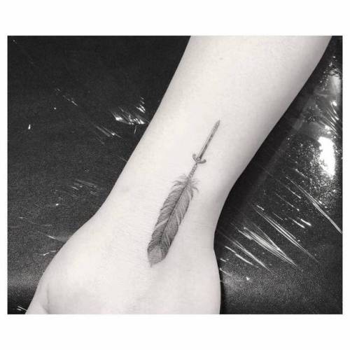 Tattoo tagged with: sword, small, single needle, native american, feather,  facebook, wrist, twitter, drwoo, weapon 