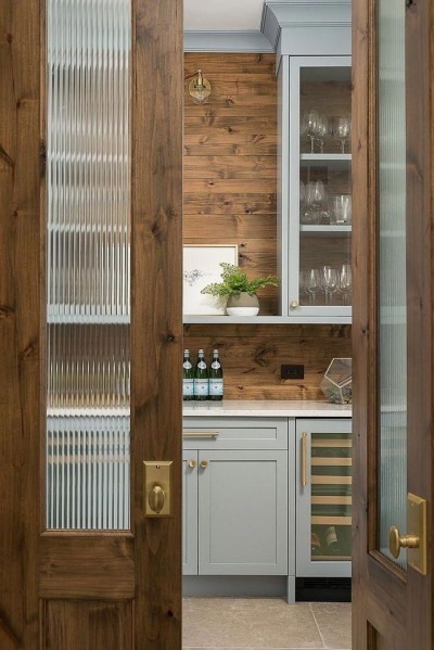 The pantry doors feature fluted glass and brass knobs