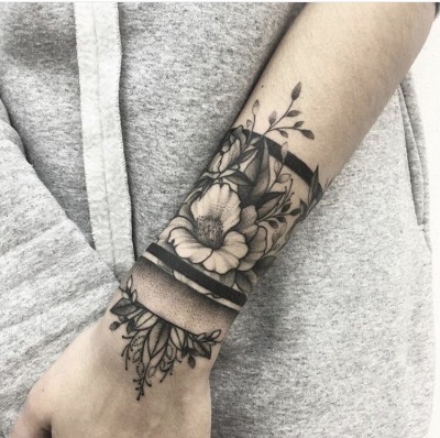 flower tattoo around wrist