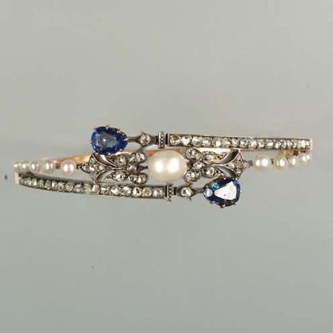 A LATE 19TH CENTURY PEARL, DIAMOND AND SAPPHIRE HINGED BANGLE...