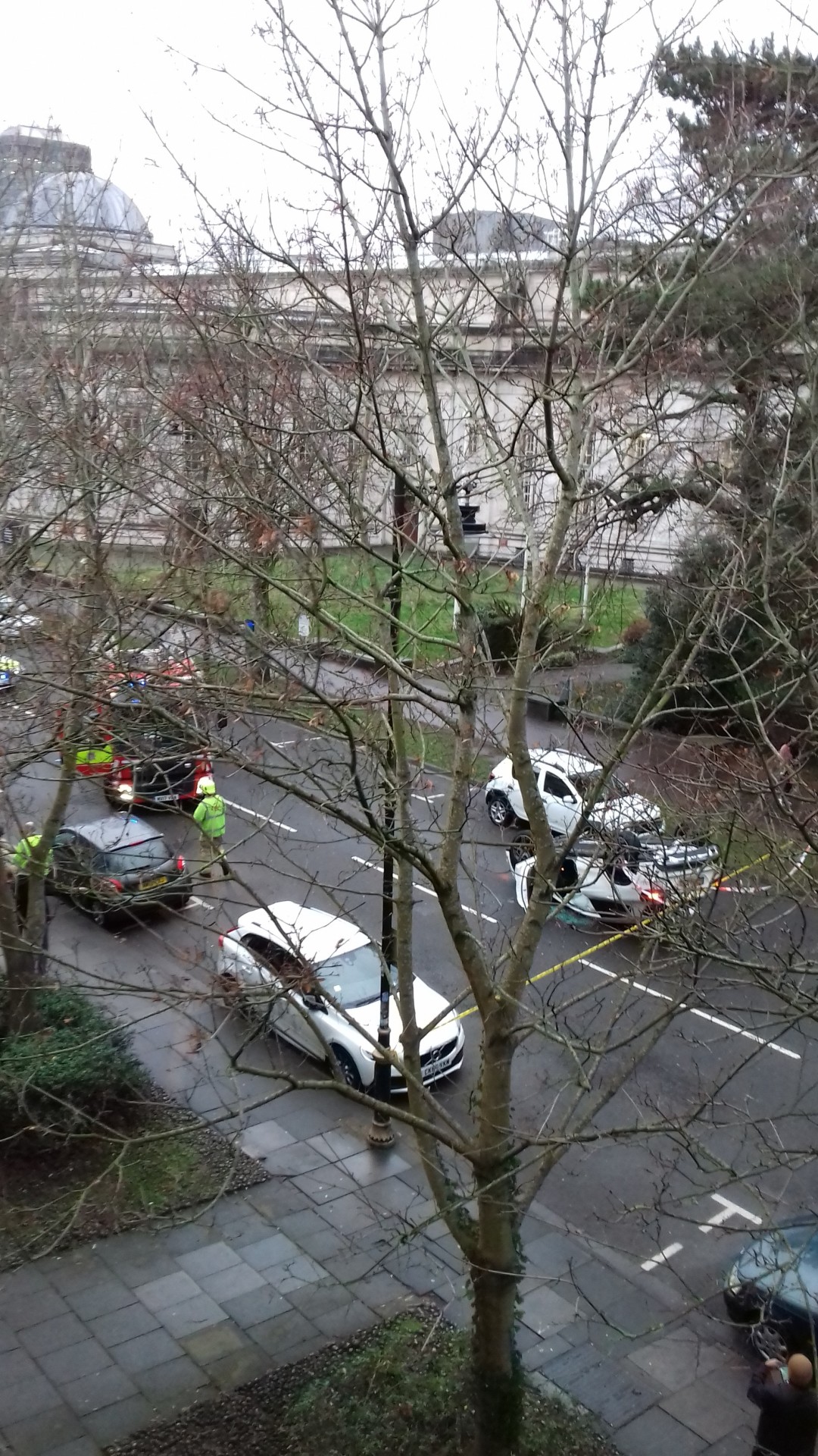street scene featuring an overturned car