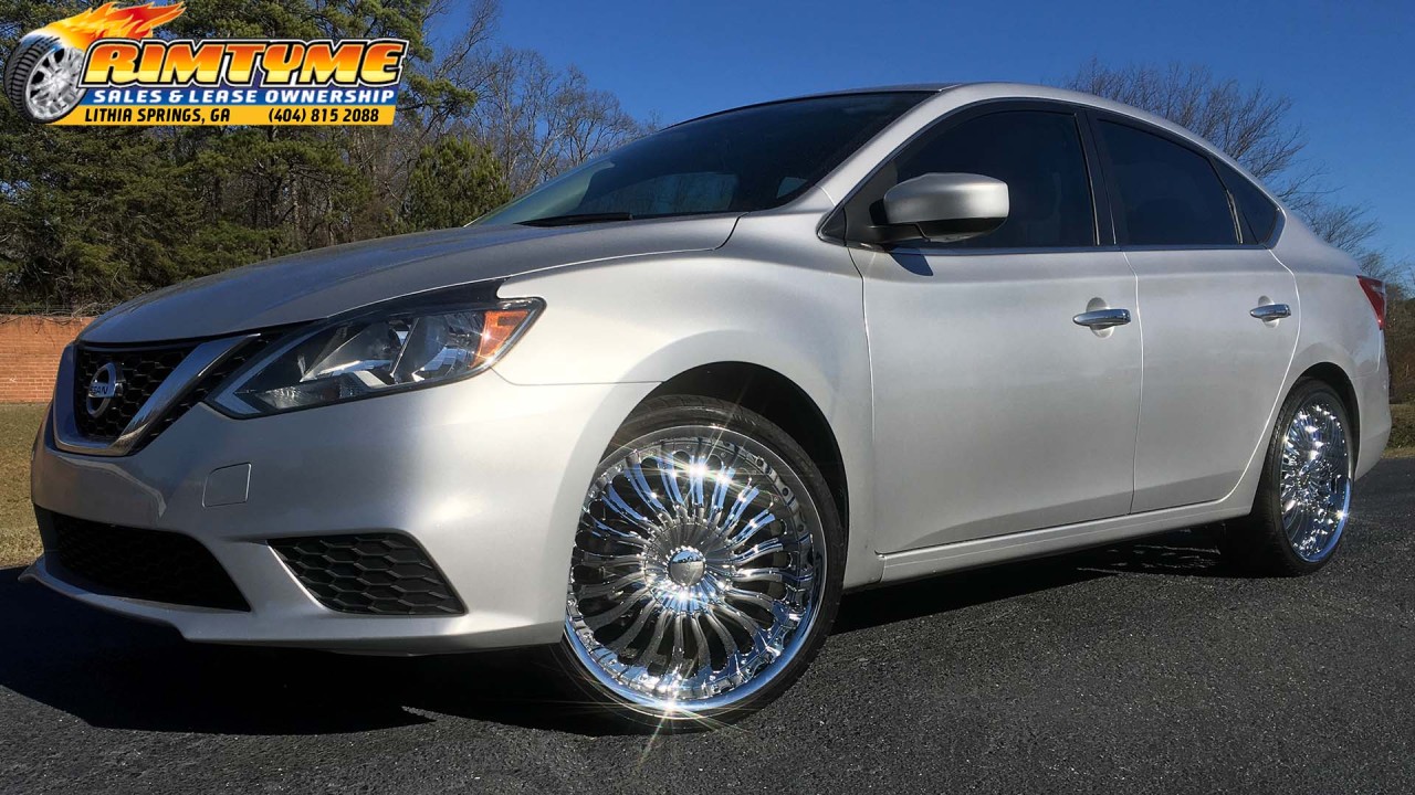 Nissan Sentra sitting on 20” Elure 033 Chrome Wheels wrapped in 225-35-20 Lexani