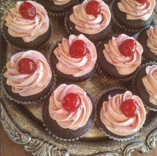 Vegan chocolate cupcakes with cherry frosting.  