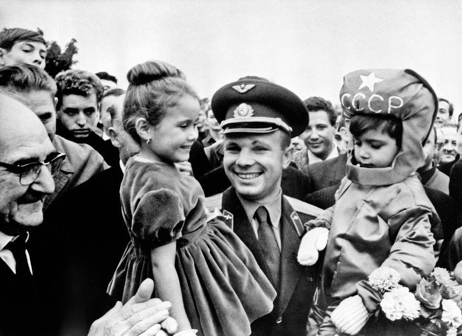 Yuri Gagarin amidst celebrations marking his space flight. The boy is dressed up as a cosmonaut, his headpiece reads USSR.