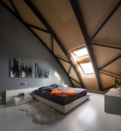 Bedroom in a modern loft apartment, formerly a commercial building, with an arcing steel beam roof line in Kiev, Ukraine. [3500 × 3795]