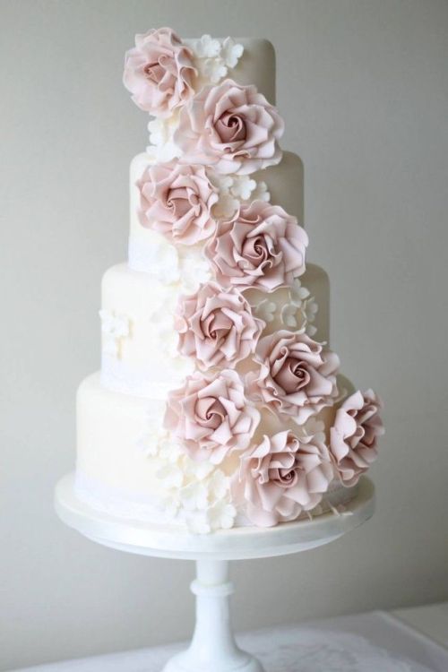 Cascading pink roses on a 4 tier ivory wedding cake
