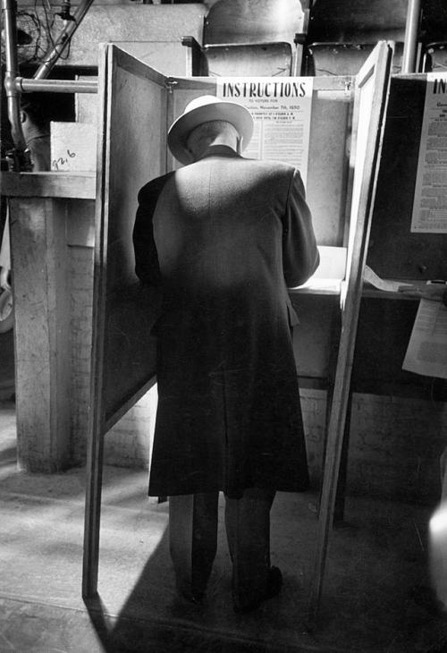 historium:President Harry Truman stands in voting booth during...