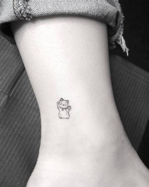 Tattoo tagged with: small, micro, line art, animal, japanese culture, tiny,  maneki neko, ankle, ifttt, little, evankim, cat, illustrative, fine line,  feline, patriotic 