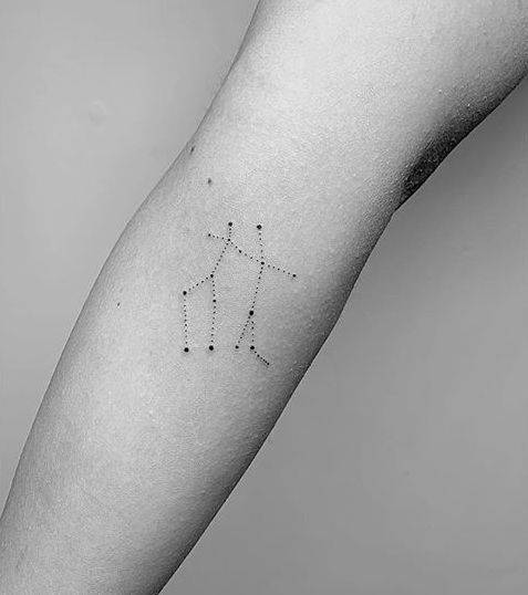 Gemini constellation tattoo on the right inner forearm