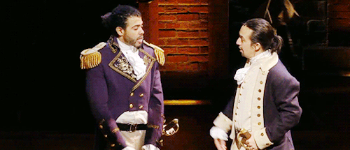 Daveed Diggs and Lin-Manuel Miranda in Hamilton high-five each other