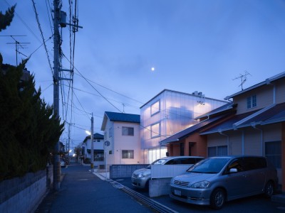 ombuarchitecture:<br /><br />House in Tousuien<br />Hiroshima • Japan<br />By Suppose Design Office<br />The House of Tousuien is located in a quiet residential area, and it is designed for a couple and 3 children. The three sides of this house are surrounded by other residence buildings, and the shape of the site forces the house to stay long and narrow.<br />Most exterior walls are thick and heavy, where windows are added to balance out the heavy look of the exterior. For the House of Tousuien, we used a thin and translucent material to replace the regular exterior walls, where natural light and be maximized in the interior space.<br />via Archdaily<br />