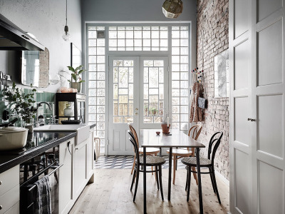 Beautiful kitchen features exposed brick, natural wood floors, and green tile to soak in the light from the back wall in this home in Göteborg, Sweden. [1024 × 769]