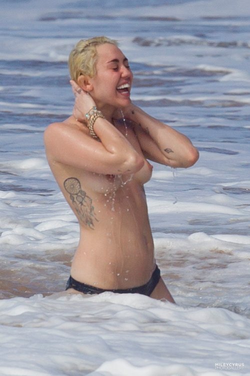 toplessbeachcelebs:Miley Cyrus (Singer) swimming topless in...