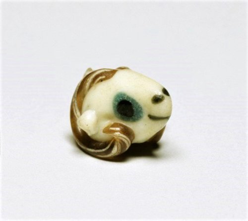 historyarchaeologyartefacts:Tiny glass ram with a sweet smile...