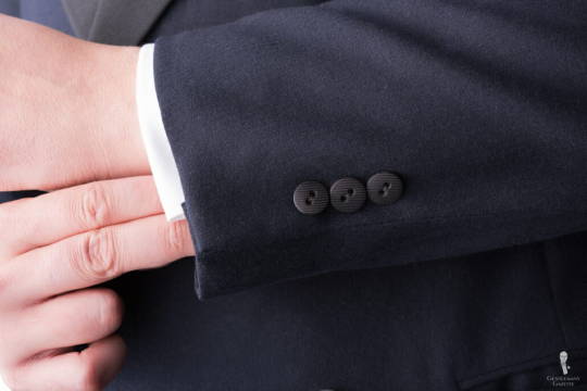 The sleeve buttons on this vintage jacket number three per sleeve, and feature faint texturing.