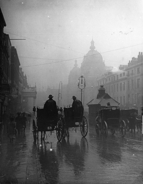 undr:F. J. Mortimer. Hansom cabs drive through overcast...