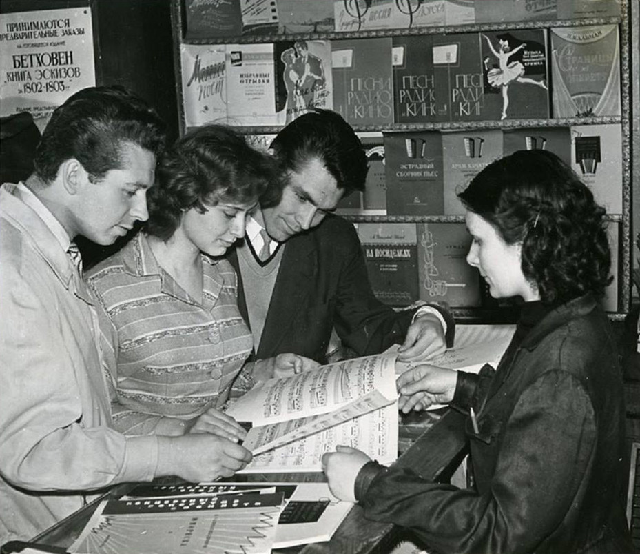 Conservatory students perusing sheet music at a music shop (1959)