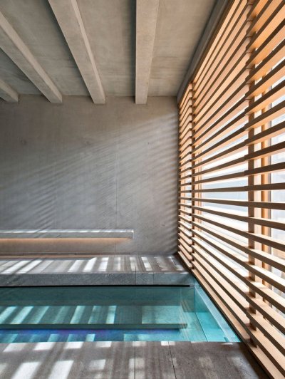 archatlas:<br /><br /><br />Hôtel des Berges’ Spa des Saules in Illhaeusern<br /><br /><br />Conceived as a contemporary reinterpretation of an Alsatian farm by the agency <br /><br />Jouin Manku, the Hôtel des Berges’ Spa des Saules <br /><br /> of 800m² reflects in its design the timber frames of the region’s large old barns, built with untreated materials the structure is built out of solid timber structure with a dark gray tiled roof, set in a concrete volume and further solidified into the ground through a smooth stone base.<br /><br /><br />Follow the Source Link for image sources and more information. <br /><br /><br />