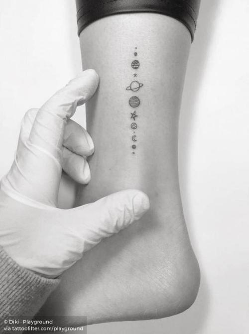 Minimalist solar system tattoo on the inner forearm
