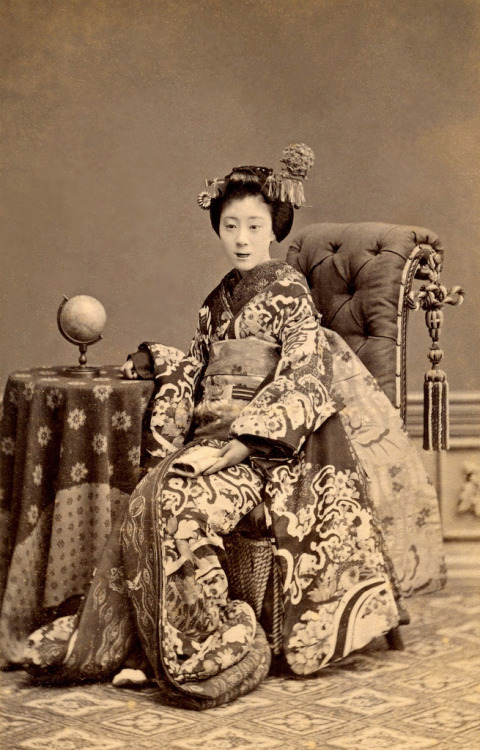 A Maiko with a Terrestrial Globe 1880s (by Blue Ruin1)
“ A Maiko (Apprentice Geisha) in full ceremonial dress, seated beside a terrestrial globe
”