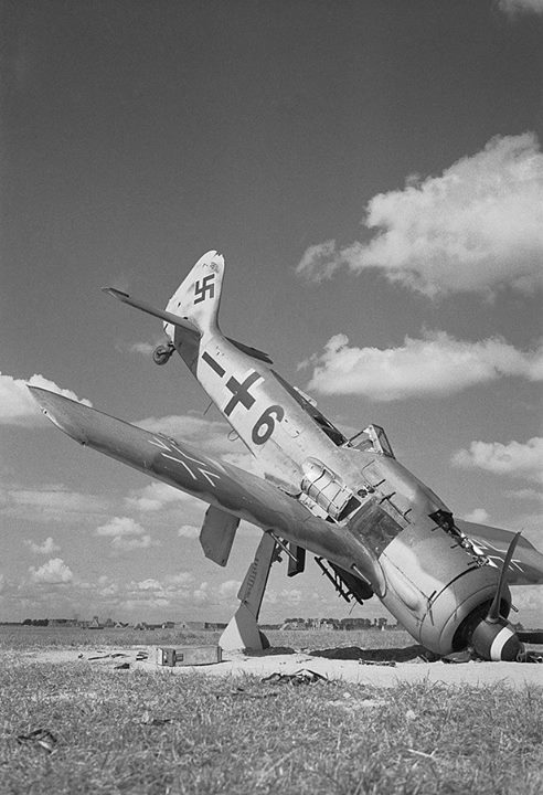 ww1ww2photosfilms:A German Focke-Wulf FW 190A-8 fighter lies...