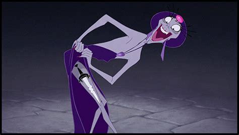 Yzma from The Emperor\'s New Groove, who is an elderly woman with gray skin, pulling up her dress to reveal a dagger strapped to her thigh.