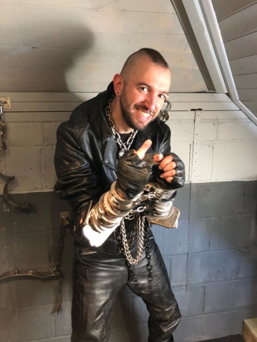 jamesbondagesx:Leather boi heavily cuffed and showing a bit of...