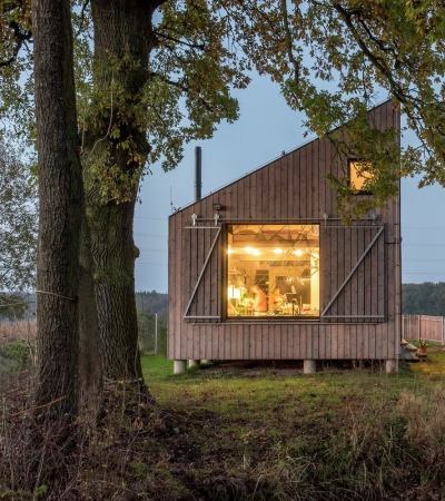 archatlas:<br /><br />Zilvar House ASGK Design<br /><br /><br /><br /><br />The experimental low-energy wooden house Zilvar won honorable mention the Architecture Grand Prix in 2014 in the Family House category. The land is located in the outskirts of a small quiet village surrounded by fields, meadows and woods and is the ideal place for peace and relaxation. The investor decided to construct a weekend house which is designed as one living space with two galleries which provides maximum communication with the garden. Its unconventional shape opens up views of the old oak tree and pond, and across the terrace to the garden’s central section.<br />Images and text via ASGK Design<br /><br /><br />