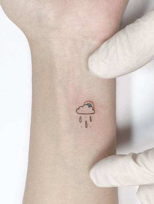 Fine line cloud and rain tattoo on the inner arm