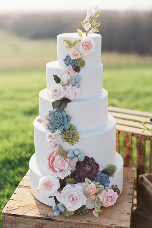 Beautiful white wedding cake with cascading floral appliques...