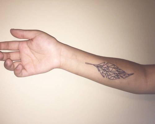 Polygon style feather tattoo on the right forearm. Tattoo... geometric shape;small;mattreid;black;tiny;polygon;native american;feather;little;forearm