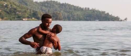 olordelaguayaba:A father teaches his son to swim at Lake Kivu,...