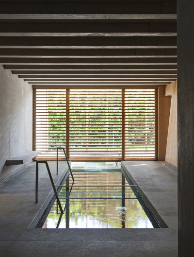 archatlas:<br /><br /><br />Hôtel des Berges’ Spa des Saules in Illhaeusern<br /><br /><br />Conceived as a contemporary reinterpretation of an Alsatian farm by the agency <br /><br />Jouin Manku, the Hôtel des Berges’ Spa des Saules <br /><br /> of 800m² reflects in its design the timber frames of the region’s large old barns, built with untreated materials the structure is built out of solid timber structure with a dark gray tiled roof, set in a concrete volume and further solidified into the ground through a smooth stone base.<br /><br /><br />Follow the Source Link for image sources and more information. <br /><br /><br />