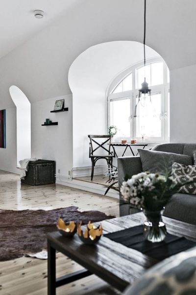 Scandinavian attic apartment has a window nook for tea or breakfast.