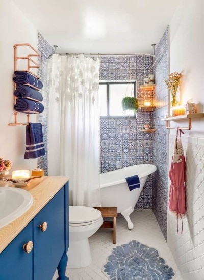 This adorably cozy cottage in Florida is filled with pastel details. We love the appliances in the kitchen, including light baby blue dishwasher and fridge and butchers block. The tiles also have baby blue details to tie the space together. The bathroom tile is a darker blue that is stunning with the dark blue vanity and claw foot tub. This adorably cozy cottage in Florida is filled with pastel details. We love the appliances in the kitchen, including light baby blue dishwasher and fridge and butchers block. The tiles also have baby blue details to tie the space together. The bathroom tile is a darker blue that is stunning with the dark blue vanity and claw foot tub.