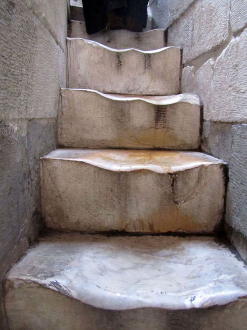 sixpenceee:The worn marble steps at the Leaning Tower of Pisa....