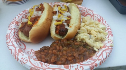 Hotdog with sause onions slaw and cheese and cowboy baked beans...