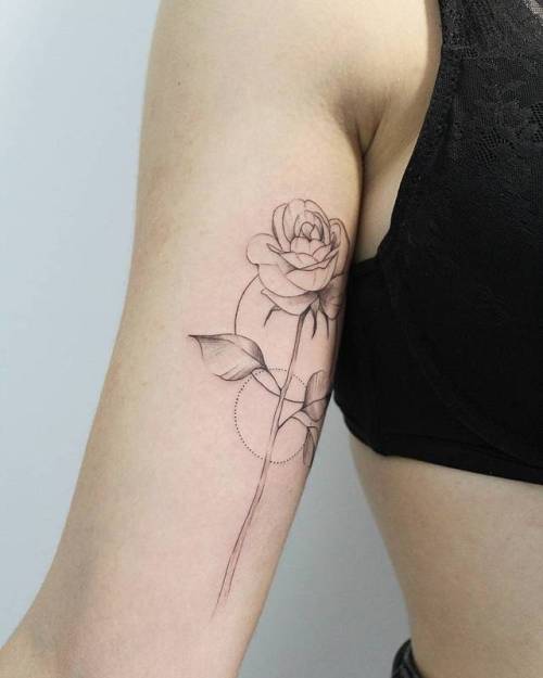 Subtle flowers tattoo on the bicep  Tattoogridnet