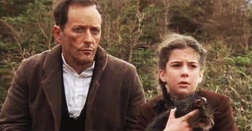 A GIF snippet of McHattie and Martha MacIsaac (holding a cat) on 'Emily of New Moon'.