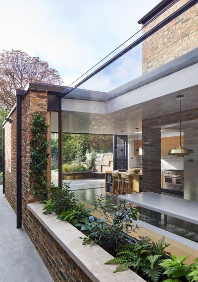 The Victorian semi-detached terraced house has been notched out and extended to the rear to create a generous kitchen, dining and living space with carefully placed glazed voids to link the interior with elements of the garden. The extension has been expressed as a lightweight pavilion extruded out from the main house, linking heavier exposed masonry elements and extending into the garden as a canopy overhanging the patio. The Victorian semi-detached terraced house has been notched out and extended to the rear to create a generous kitchen, dining and living space with carefully placed glazed voids to link the interior with elements of the garden. The extension has been expressed as a lightweight pavilion extruded out from the main house, linking heavier exposed masonry elements and extending into the garden as a canopy overhanging the patio.