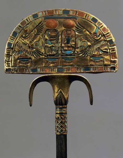 Ostrich Fan of TutankhamunThis ceremonial fan originally held ostrich feathers. It is made of wood covered with sheets of gold and inlaid with colored glass, turquoise, lapis lazuli, carnelian, and translucent calcite.
The handle is inset with gold...