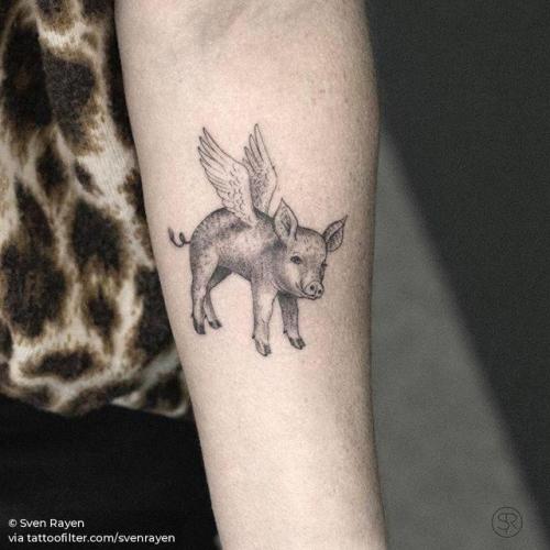 Tiny cow and pig tattooed on the inner forearm.