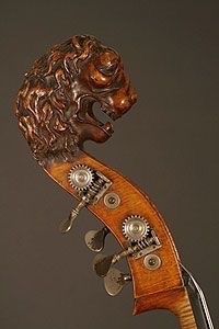 Carved lion headstock on an antique French upright bass.