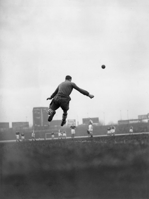 undr:A. Hudson. Arsenal goalkeeper George Swindin kicks the ball...