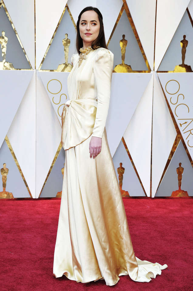 Dakota Johnson on the red carpet at the Oscars in...