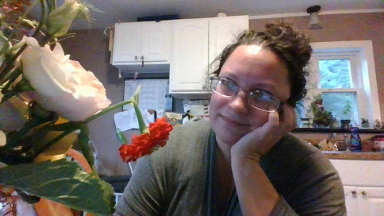 Me in the kitchen looking at a bouquet of flowers