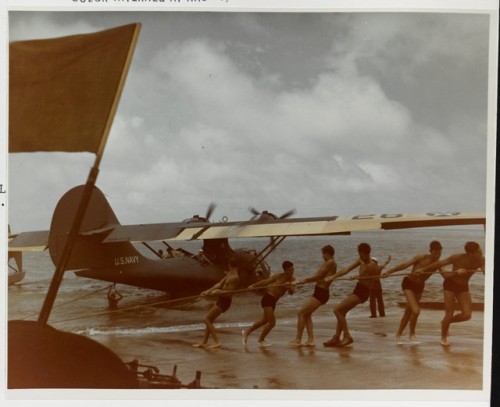 usaac-official:Ground crew pull a PBY-3 up a seaplane...