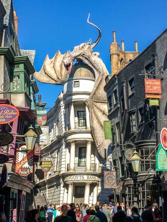 The Wizarding World of Harry Potter street with Gringotts Bank and Dragon
